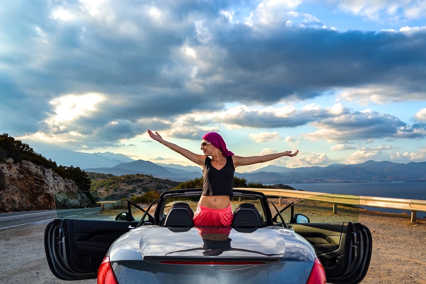 travel-by-car-the-girl-stands-on-the-hood-of-a-ca-2025-01-09-18-48-39-utc